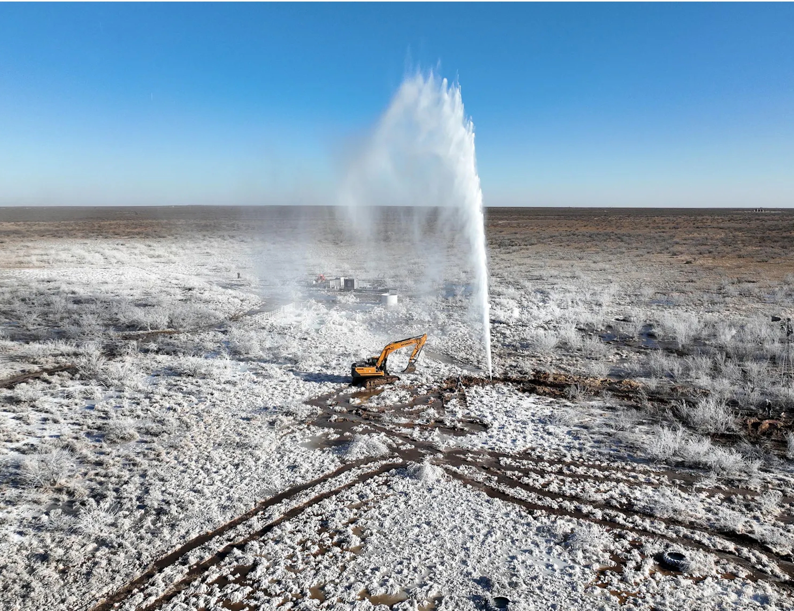 Oil produced water spews high in the air from a former oil well in Crane County, Texas
